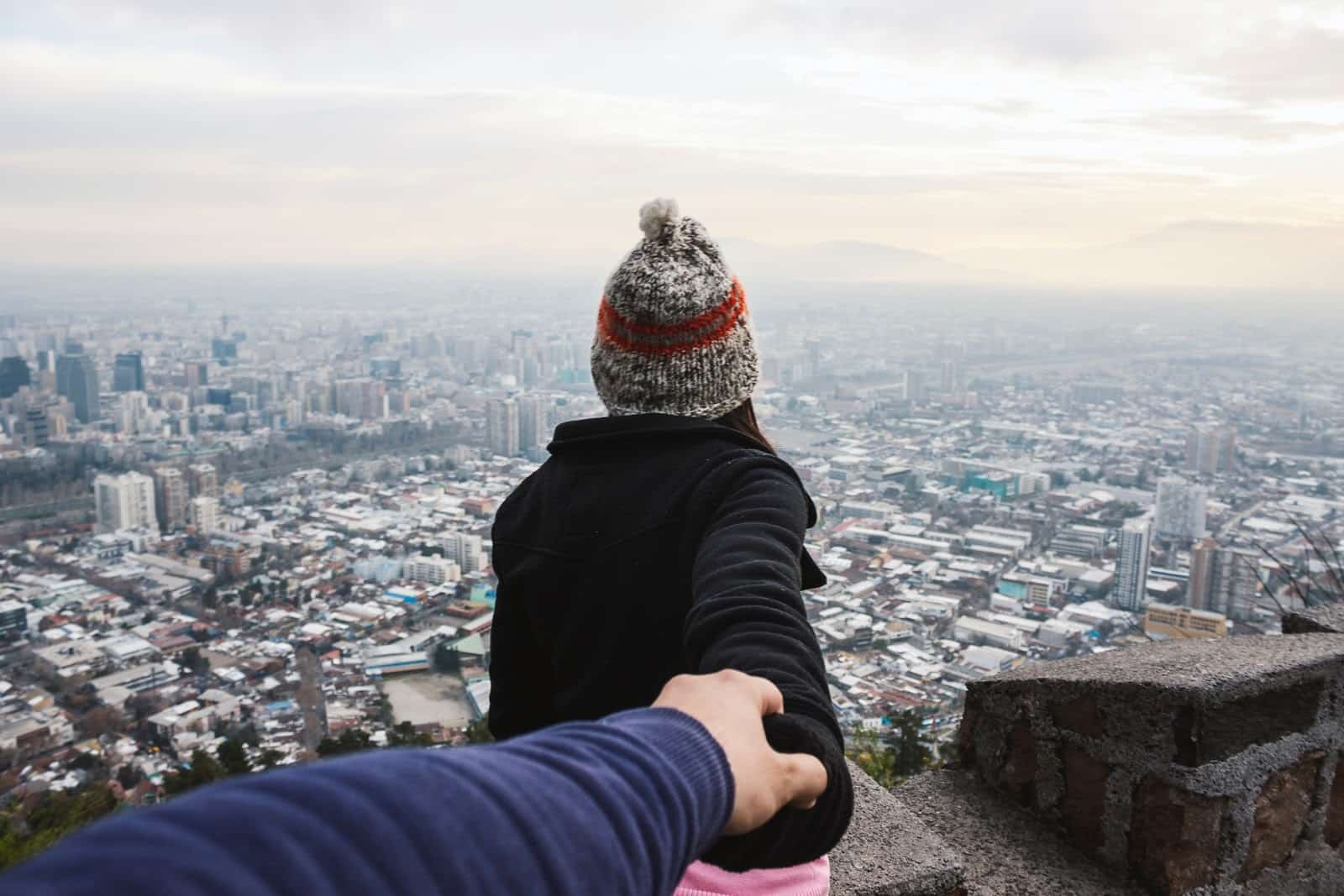 A Ukrainian woman holding her boyfriend’s hand.