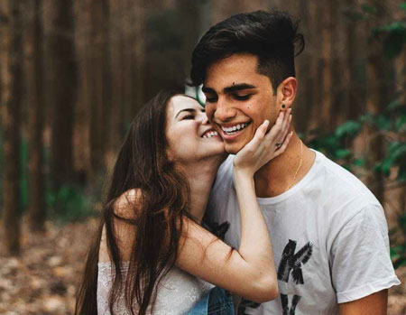 A Ukrainian woman kissing her boyfriend on the cheek