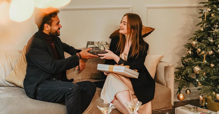 A man and woman exchanging gifts.