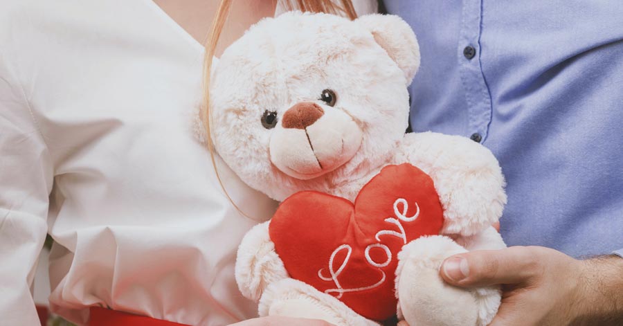 couples holding a teddy bear